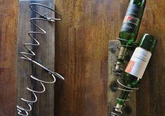 two wine bottles are sitting on a wooden shelf next to a bottle opener and corkscrew