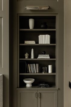 a bookshelf filled with lots of books in a room