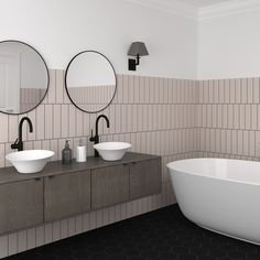 a bathroom with two round mirrors above the sinks and an oval mirror on the wall