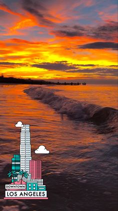 an orange and blue sunset over the ocean with buildings in the foreground, and clouds in the background