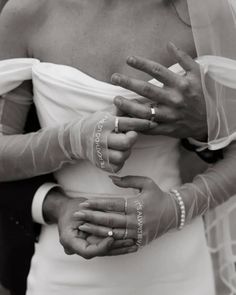 a woman in a wedding dress holding her hands with the word love written on it