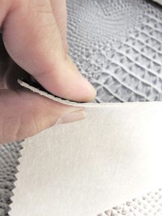 a person is cutting fabric with scissors