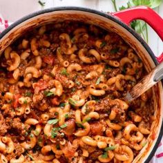 a pot filled with pasta and meat sauce