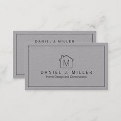 two gray business cards with a house logo on them