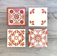 four orange and white tile designs on a wooden surface with wood planks in the background