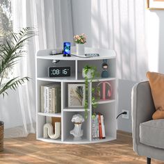 a room with a couch, chair and clock on the shelf