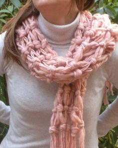 a woman wearing a pink knitted scarf