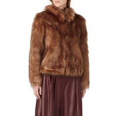 Mocha brown faux fur (80% Acrylic, 20% Modacrylic). Jacket. Long sleeves. Pockets. Satin lining. 21" from shoulder to hemline. Imported. Brown Faux Fur Winter Outerwear, Brown Fur Coat With Faux Fur Lining, Brown Fur Coat With Faux Fur Trim, Brown Fur Coat With Faux Fur Trim For Winter, Brown Faux Fur Trim Coat For Fall, Brown Long Sleeve Fur Coat With Faux Fur Trim, Chic Brown Fur Coat For Fall, Brown Fur Coat With Feather Trim, Brown Long Sleeve Fur Coat With Feather Trim