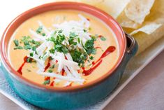 a bowl of soup with tortilla chips on the side