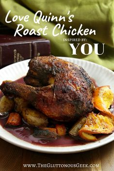 a white plate topped with roast chicken next to potatoes and an old book on a table