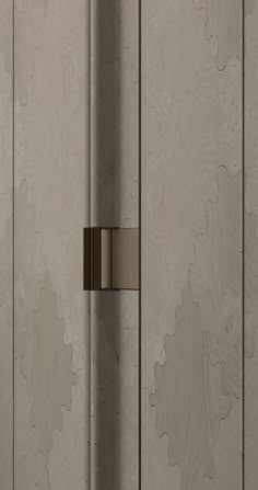 a door handle on the side of a white wall with wood grained paneling