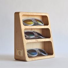 three tiered wooden display with glasses on it