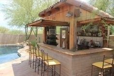 an outdoor bar next to a swimming pool