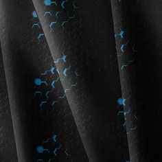 a black background with blue stars and lines on the bottom half of it, as well as dark fabric