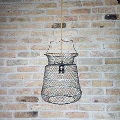 a light fixture hanging from the side of a brick wall