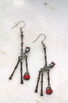 Elegant red bag lady skeleton earrings. Creepy but sweet, scarry but cute, frightening but happy... These earrings make you smile and add C-class horror movie look to your outfit. Check it and test how addictive skeletons earrings might be #skullmakeup #skullart #skullhead #skulljewelry #skullearrings #skulladdict #skulladdiction #earringsforsale #etsyearrings #halloweencostume #halloweenjewelry #halloweenearrings Red Novelty Jewelry For Halloween, Spooky Red Halloween Jewelry, Red Earrings As Halloween Gift, Red Earrings For Halloween Gift, Red Metal Halloween Earrings, Quirky Red Jewelry For Gifts, Red Halloween Earrings, Fun Red Jewelry For Halloween, Red Fun Halloween Jewelry