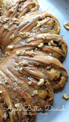 a bundt cake covered in icing and nuts