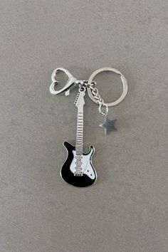 a guitar keychain with a heart shaped keyring attached to it's neck