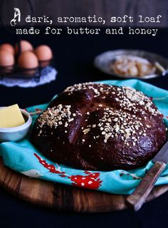 a loaf of bread sitting on top of a wooden cutting board