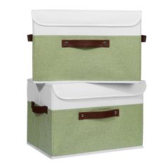 two green and white storage boxes with leather handles on each side, one in the same color