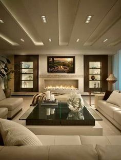 a living room filled with furniture and a fire place in the middle of the room