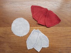 three pieces of felt sitting on top of a wooden table