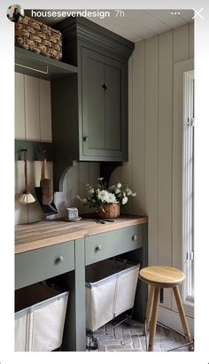 an image of a kitchen setting with grey cabinets and white flowers on the counter top