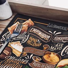 a restaurant menu is displayed on a wooden table