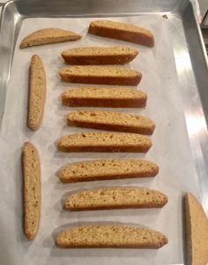 several pieces of bread sitting on top of a baking pan next to eachother