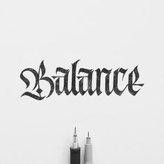 the word balance written in black ink on a white wall next to two electrical wires