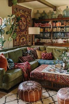 a living room filled with lots of furniture and bookshelves on top of it