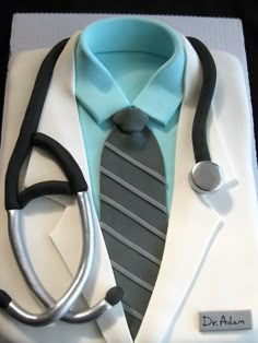 a cake with a stethoscope on top of it that is shaped like a doctor's coat and tie