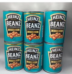 four tins of beans are stacked on top of each other