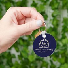 a hand holding a keychain that says melanie williams on the front