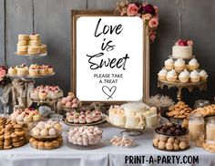 a table topped with lots of desserts and pastries next to a sign that says love is sweet