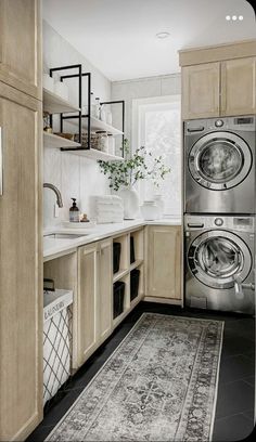 a washer and dryer sitting in a kitchen next to each other on a rug