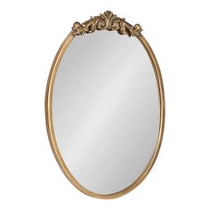 a gold oval mirror with an ornate frame