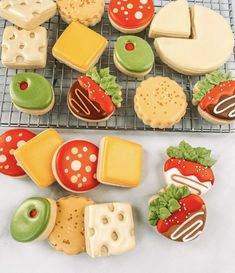 cookies and pastries are arranged on a cooling rack