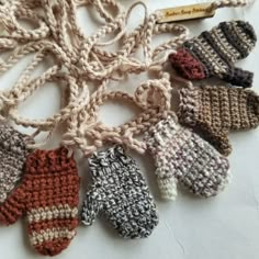 several knitted mittens laid out on a table