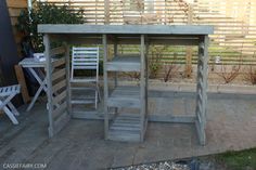 a wooden table and chairs on a patio