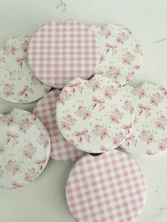 six pink and white gingham coasters with flowers on them