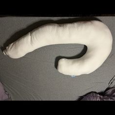 a large white pillow sitting on top of a bed