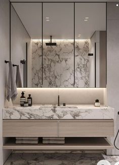 a modern bathroom with marble counter tops and white walls, along with two mirrors on the wall