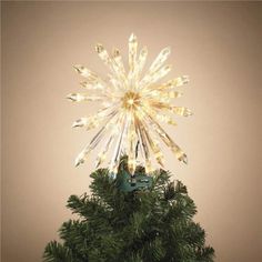 a small christmas tree with lights on it's top and an ornament in the middle