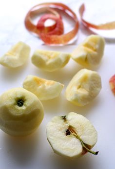 sliced up apples sitting on top of a white table