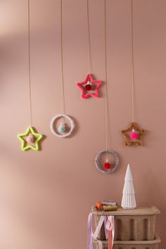 there are many ornaments hanging on the wall in this room with pink walls and flooring