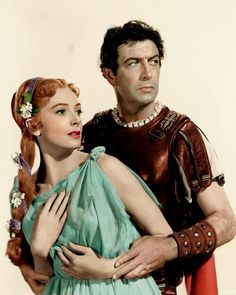 an image of a man and woman dressed in roman costumes with one holding the other