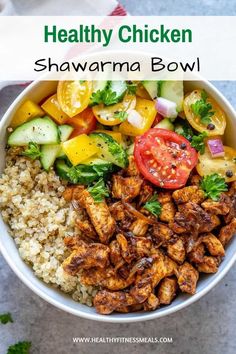 healthy chicken shawarma bowl with rice, tomatoes and cucumbers in it