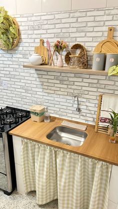 a kitchen with white brick walls and wooden counters