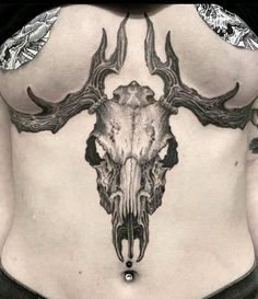 the back of a woman's stomach with an animal skull and antlers on it